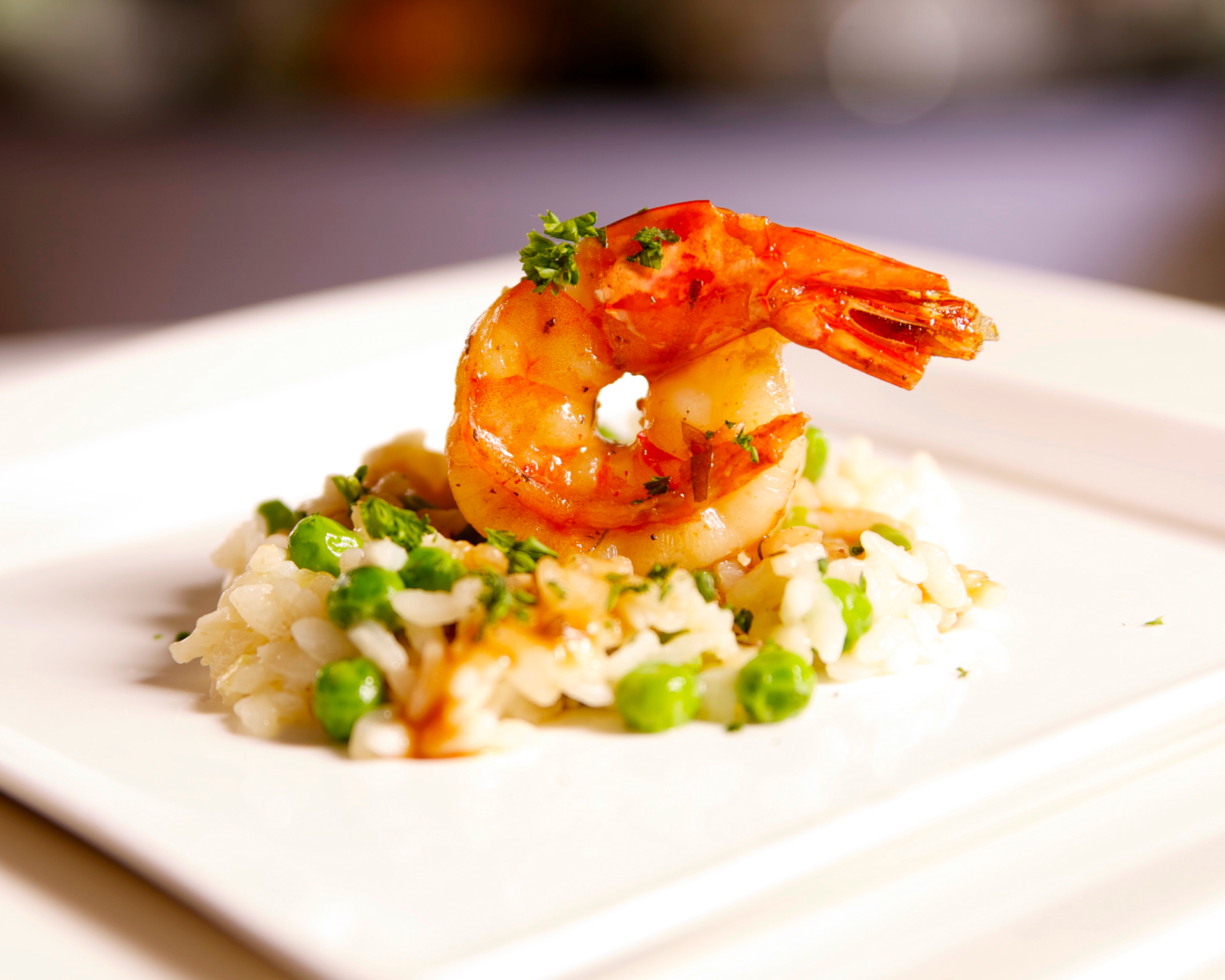 Seared shrimp over pea risotto